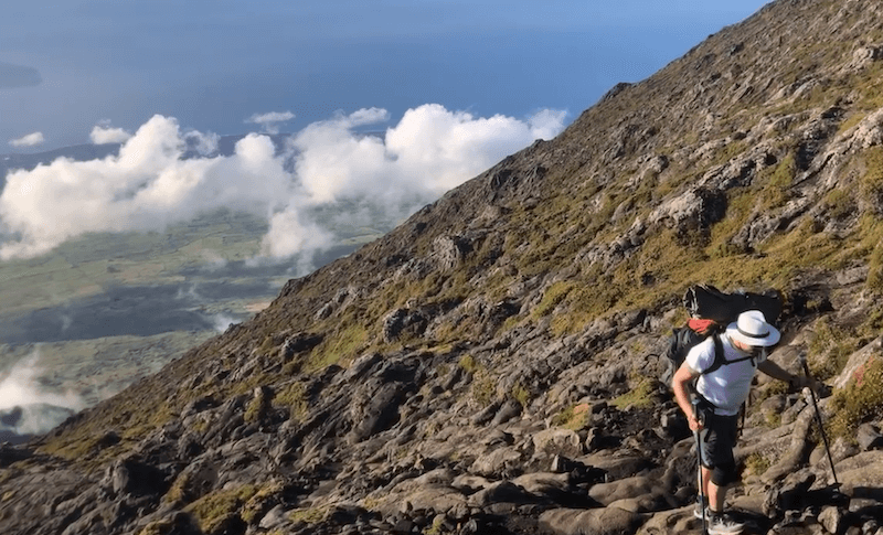 man going up mountain